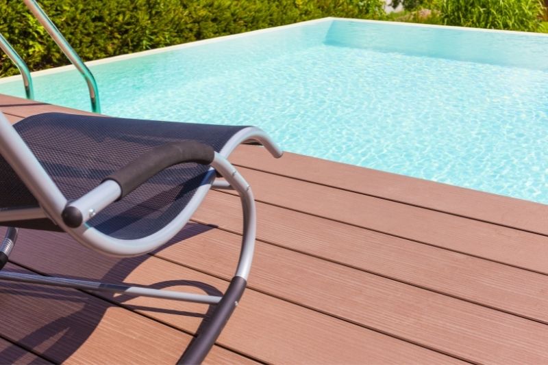 Outdoor deck chair beside a pool on a composite deck