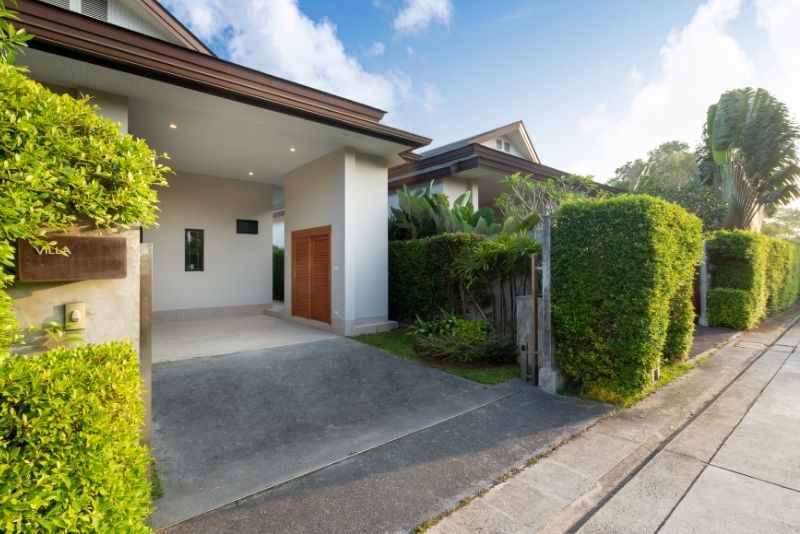 Roofed carport built into a home's driveway entrance